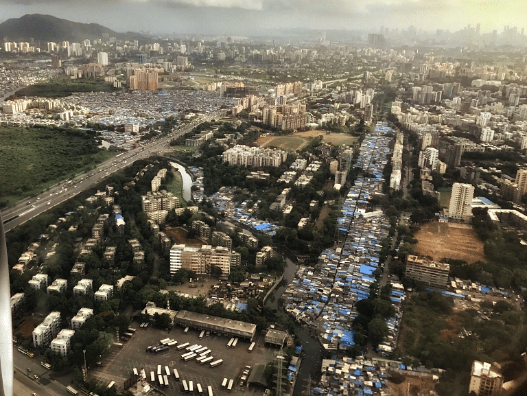 A beautiful overhead shot of the city showing all the buildings and cloudy sky in the background.