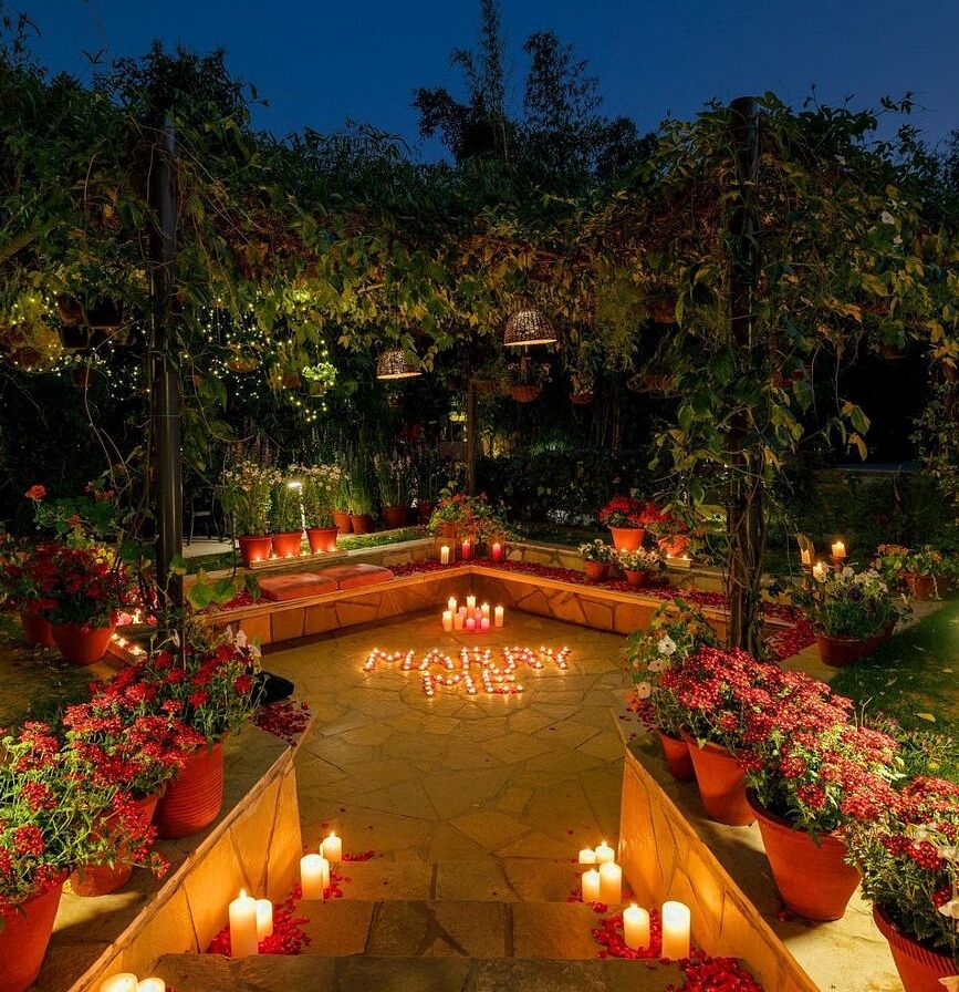 Night view of garden pathway with stairs lit by candles and surrounded by plants at Karma Chalets.
