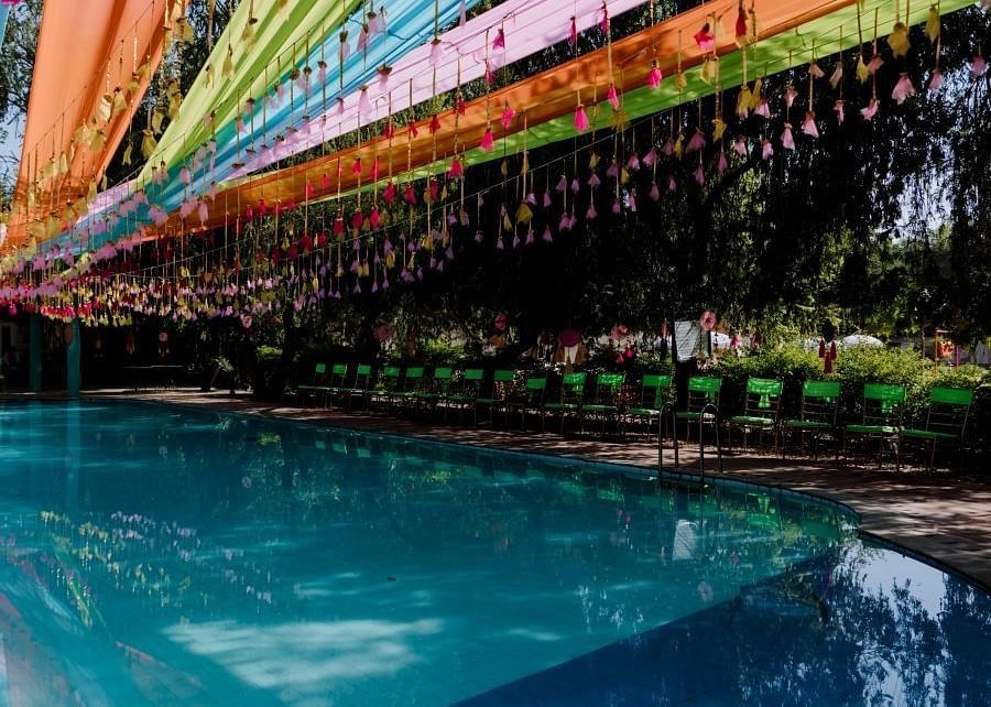A poolside wedding venue with colourful decorations at a Heritage Resort in Jaipur - Umaid Palace - A Lakeside Heritage Palace Resort