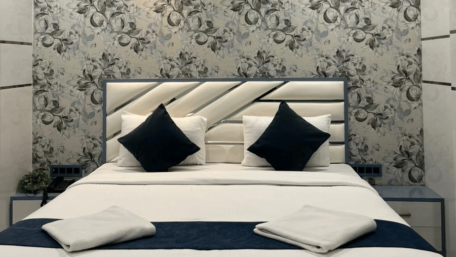 Deluxe hotel room with a plush bed, elegant interiors, and ambient lighting for a relaxing stay.