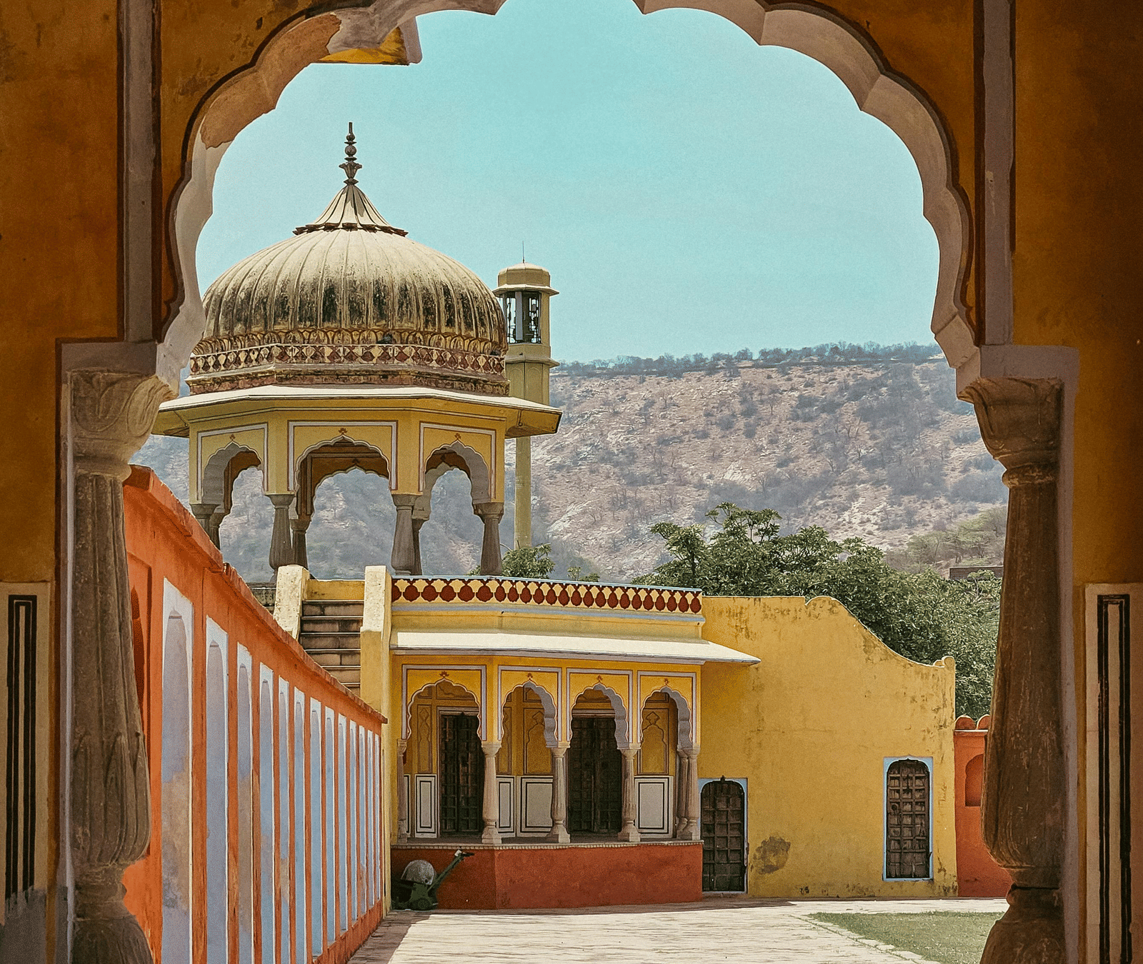 Arched doorway opening to courtyard and traditional architecture