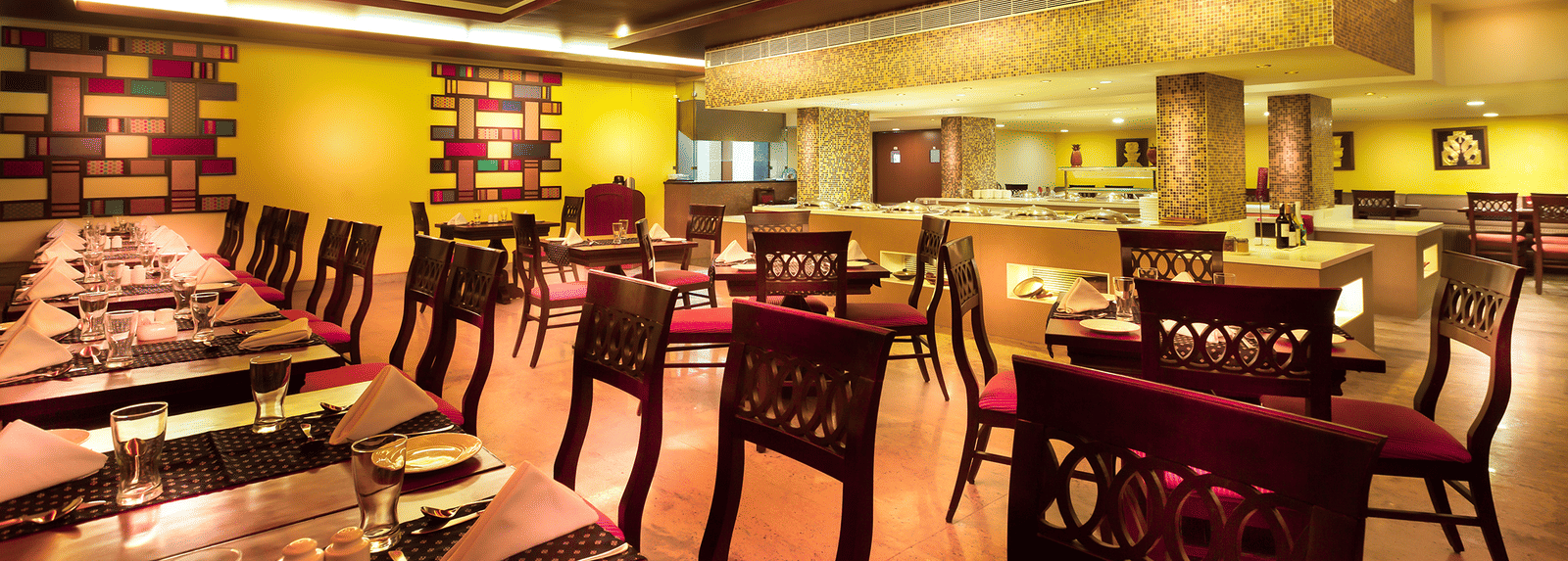 An image of a dining space with tables and chairs | Regency Madurai by GRT Hotels