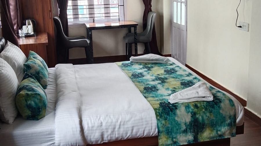 Side view of the double bed inside Deluxe room - Ecotel Kolkata