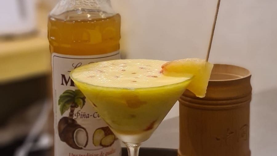 A glass bottle of drink and liquid in a glass placed in a tray | Matsya Island Retreat