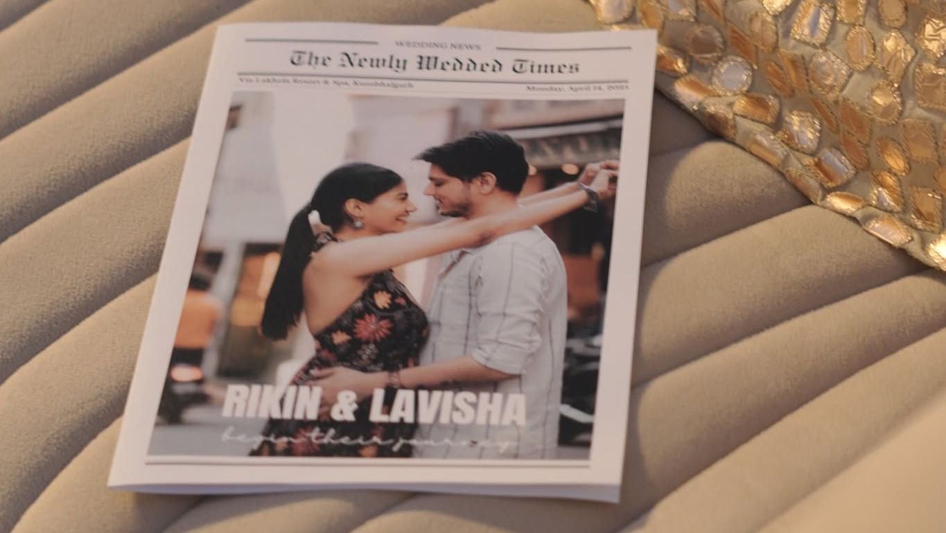 Lavisha and Rikin exchange vows under a floral canopy with draped fabric, surrounded by loved ones at their Kumbhalgarh wedding.