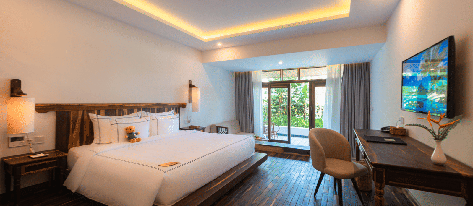 Balcony Room with king bed, wood flooring, and balcony at Alibu Resort Nha Trang.