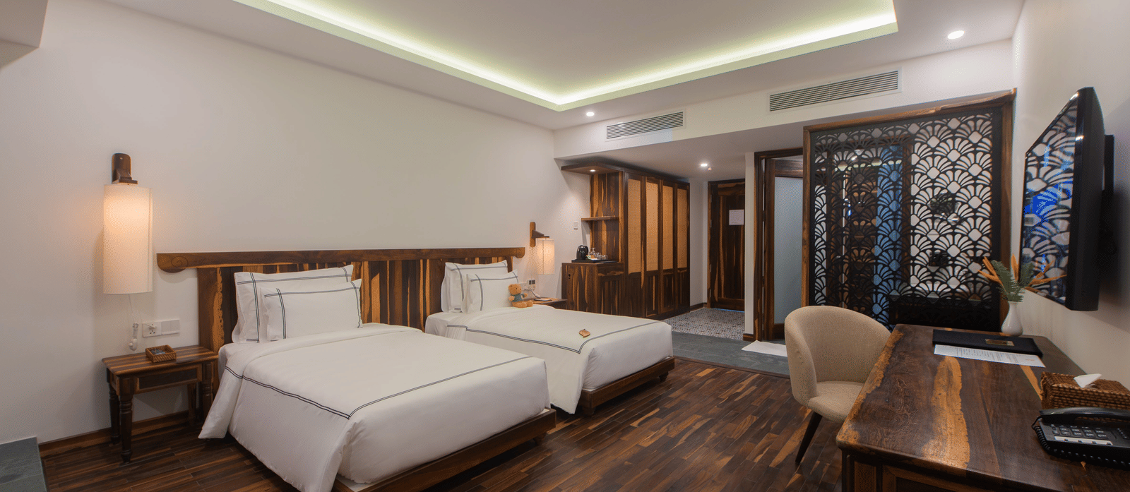 Balcony Room at Alibu Resort Nha Trang with twin beds, bedside lamps, wardrobe, and wood flooring.