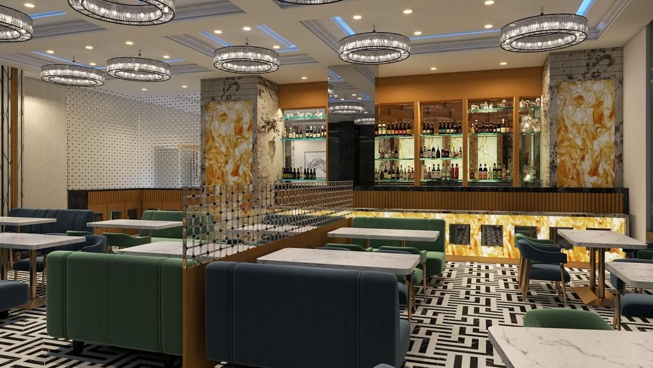 Dining space with a patterned carpet, featuring chairs and tables arranged on it at Hotel Mumbai House, Vashi.