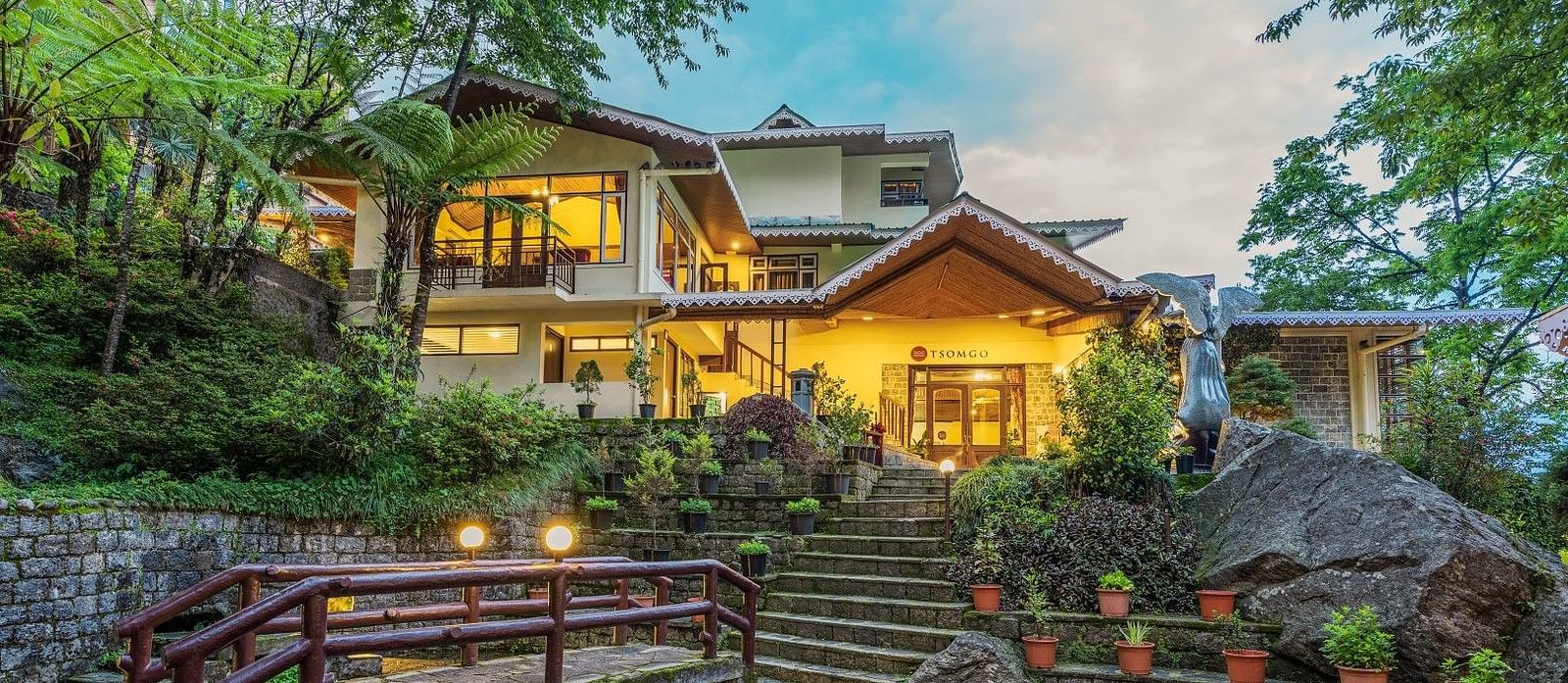 Hotel facade with stairs leading from the pond to the Tsomgo