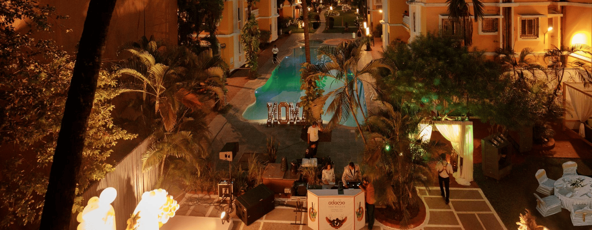 A view of the hotel building with the pool during dusk.