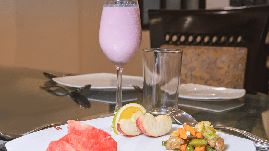A beautifully plated food served with a juice at Manorath Restaurant at Shri Vallabh Vilas Lords Plaza Nathdwara.