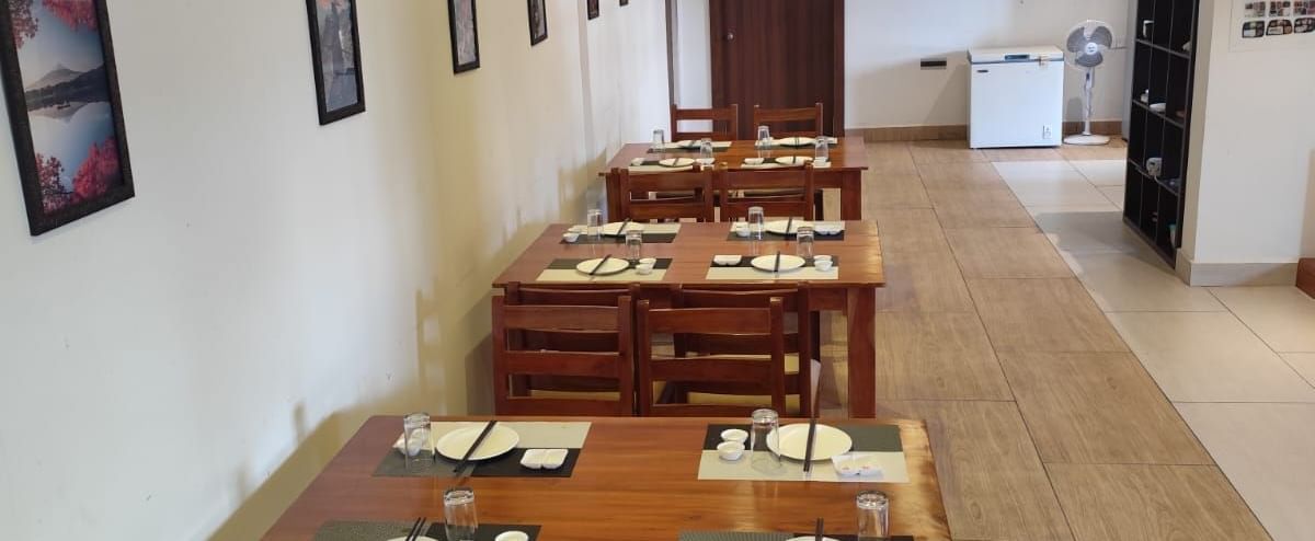 Full view of the Ajito restaurant featuring several dining tables arranged against the wall at one side at Ilara Hotels & Spa, Tada.