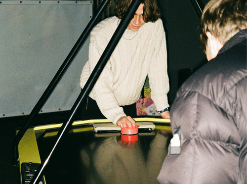 people playing air hockey