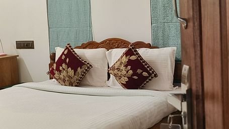 View of a double bed from the door of 104 room at Ananda Holiday Home, Wayanad 1