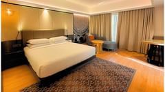Deluxe Room with seating area and large windows