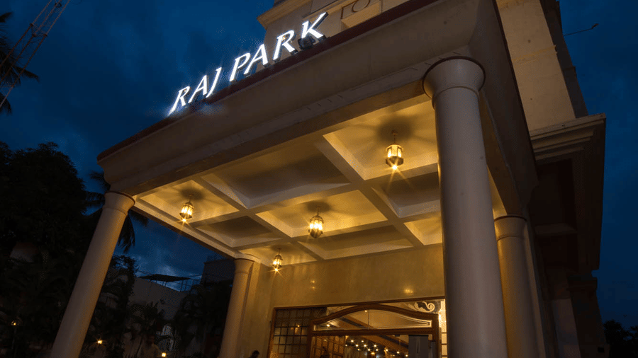 Facade of Hotel raj Park, chennai with dark sky in the backdrop.