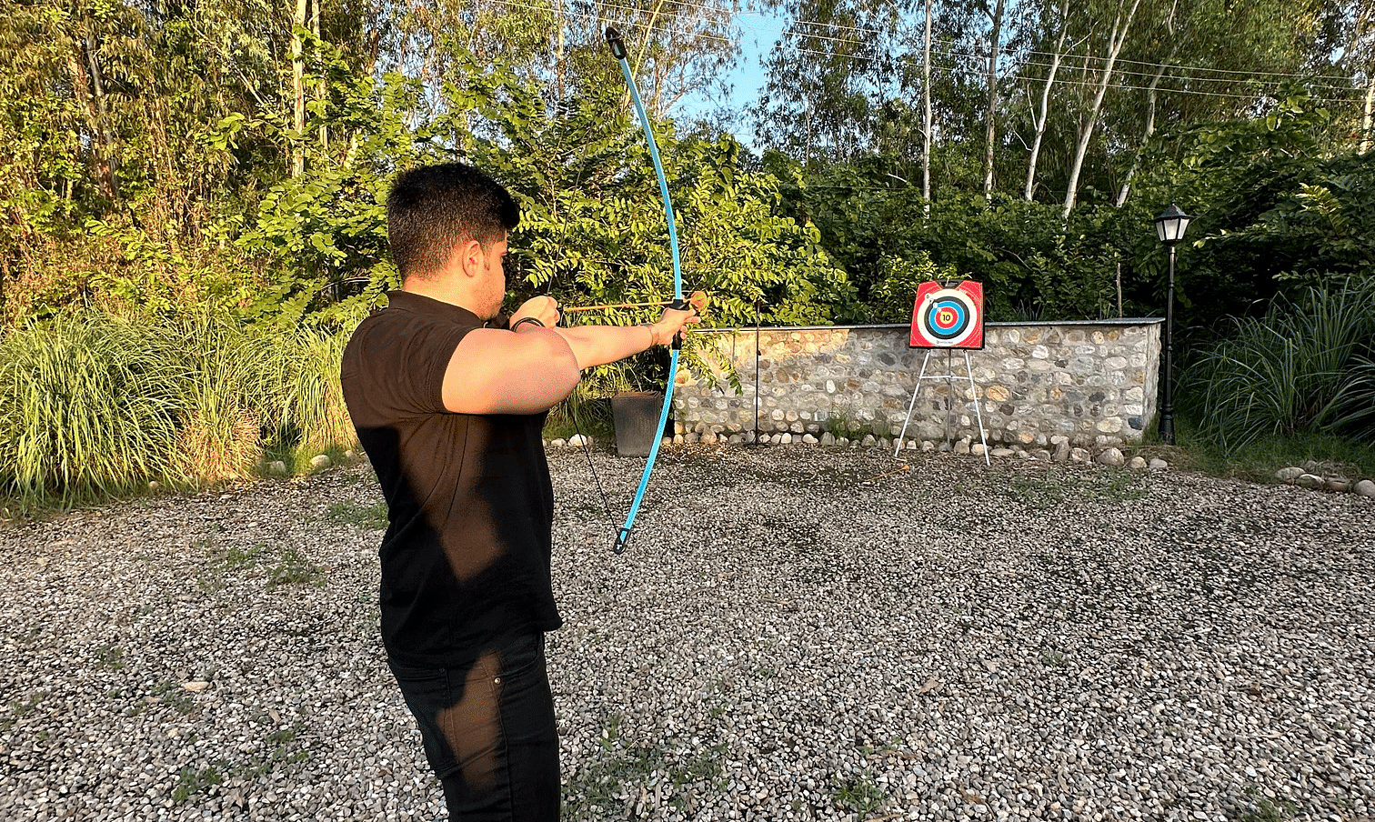A person enjoying archery activity at our resort near Haridwar - Aalia Jungle Resort & Spa