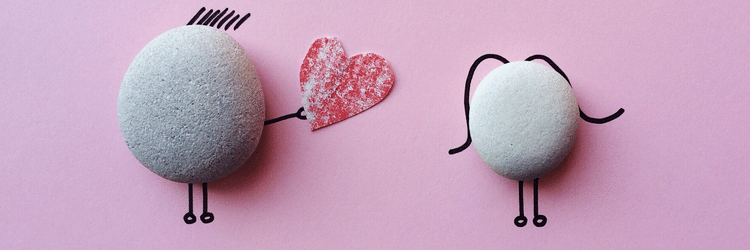 a caricature of two pebbles where one confesses its love to the other