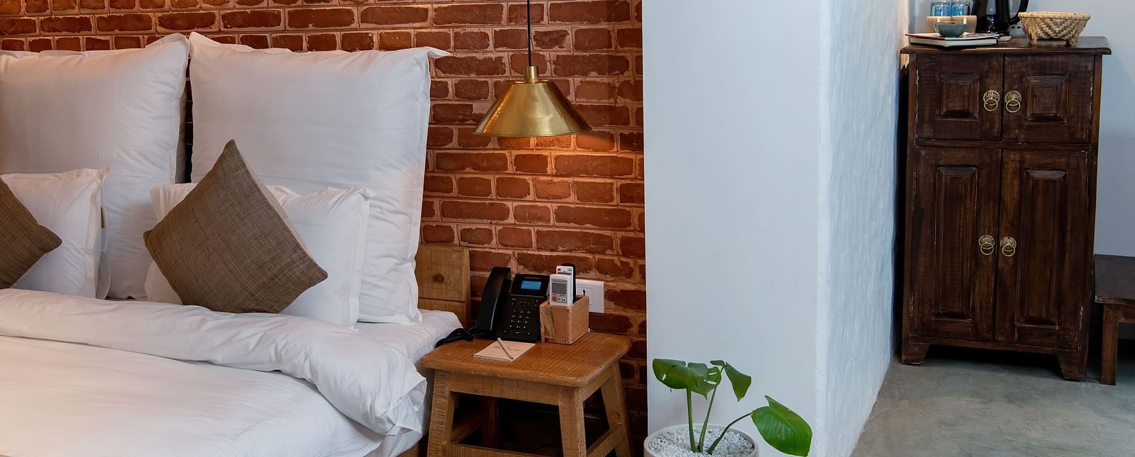 The Nepali Suite featuring a bed with pillows and cushions - The Nanee