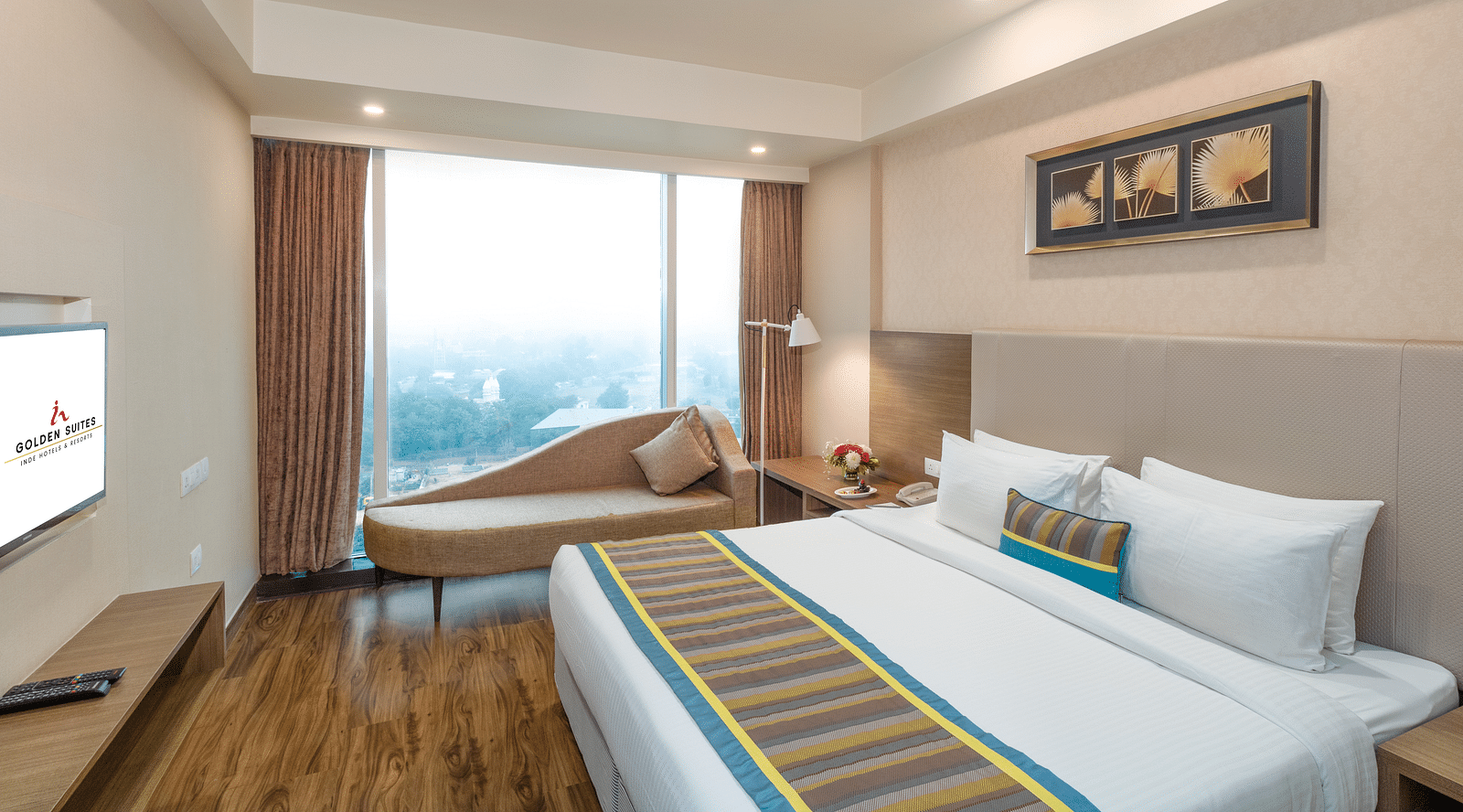 Suite Bed room with comfy bed and window view at golden suite