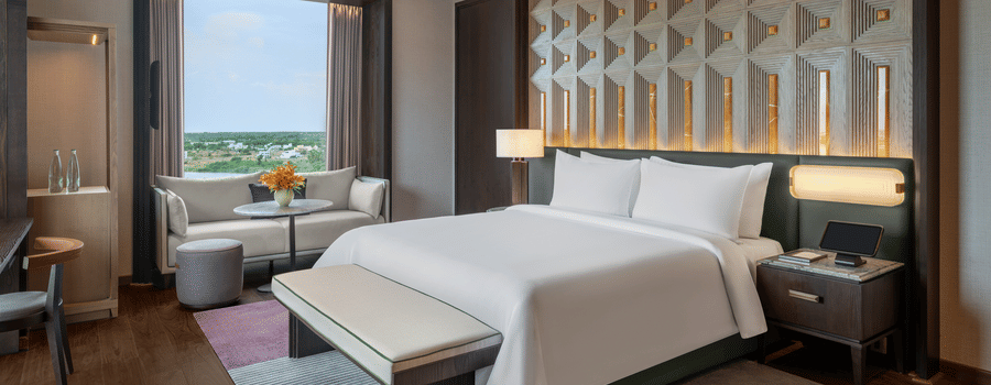 Presidential Suite Room 8001 Bedroom 2 with a bed and window garden view at The Residency Signature Madurai.