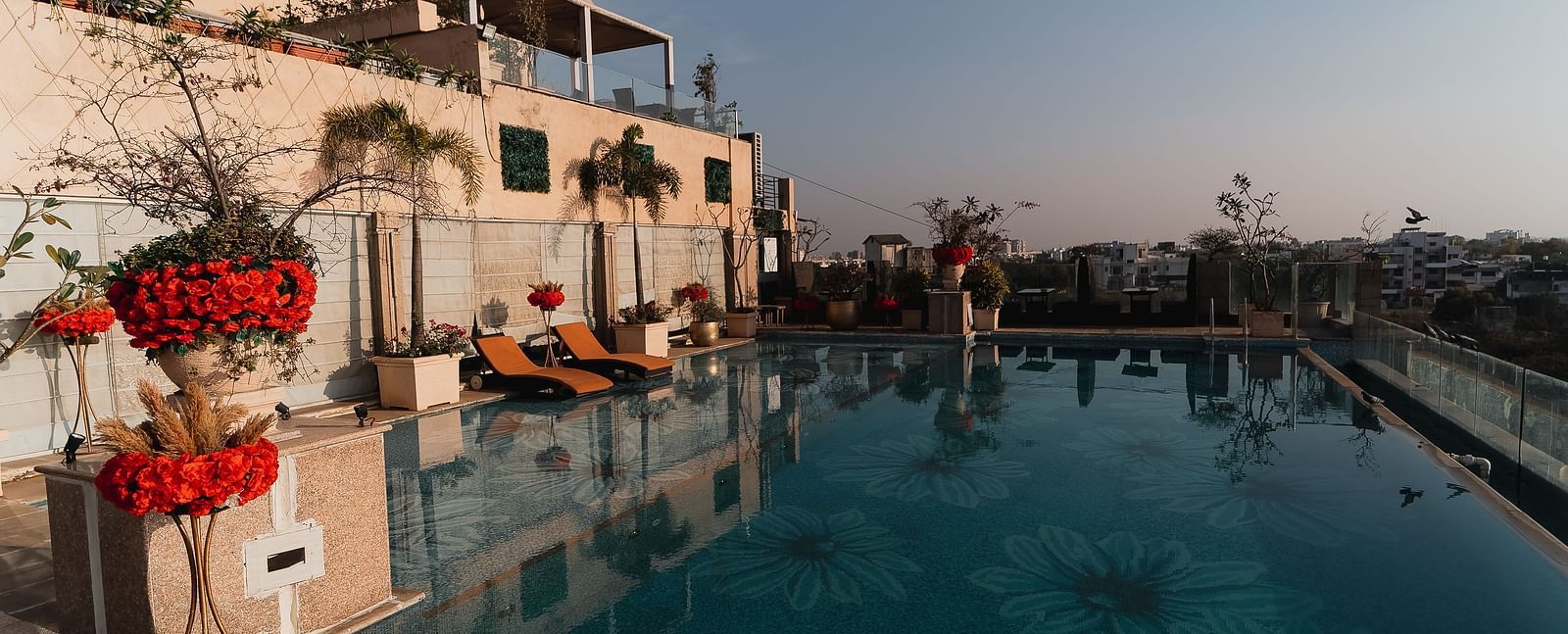 An outdoor swimming pool at Hotel Ashok Nagpur during the day.
