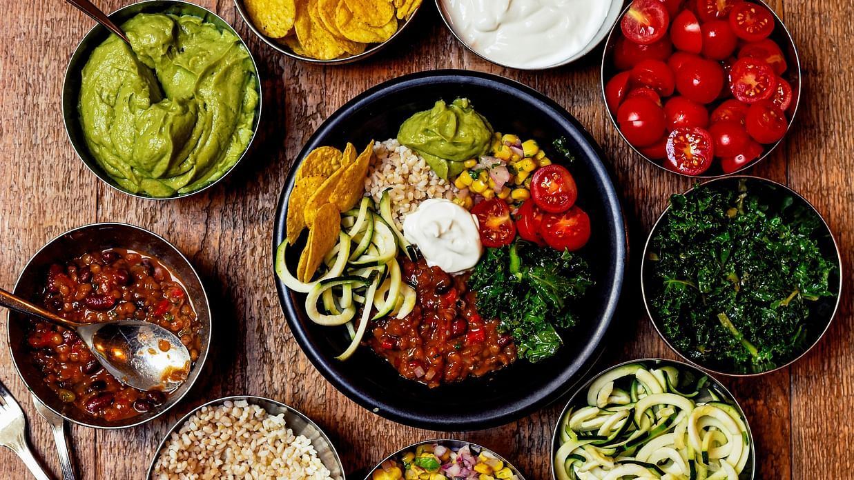assorted vegetarian food bowls on a table