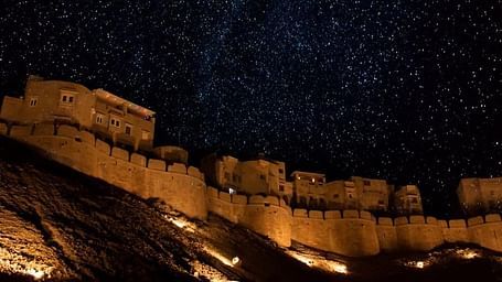 Mehrangarh Fort at night with the light on and under the stars