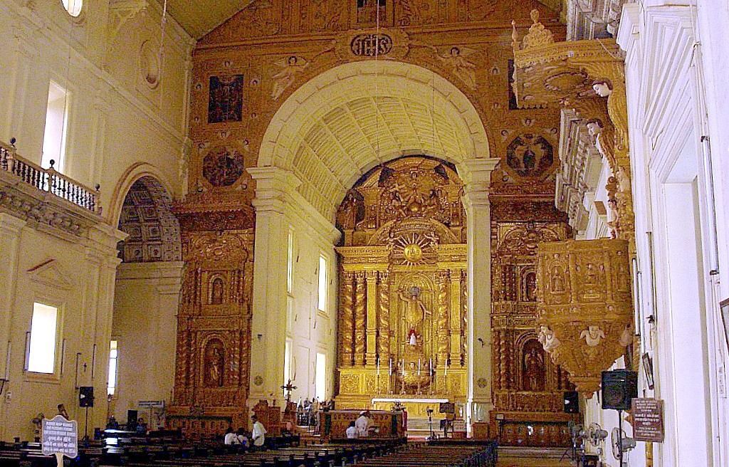 Cathedral with people sitting on the pews and worshipping Jesus Christ