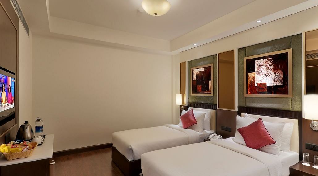 view of twin bed in Premium twin room of Inde Hotel Vista Woods, Gurgaon 