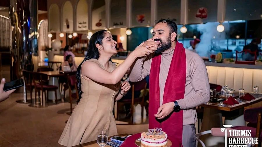 Guests celebrating a special moment by feeding cake to each other at Themis Barbecue House, Ambala