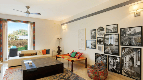 An overview of the living room with paintings and other decorations inside one of the villas - Karma Lakelands.