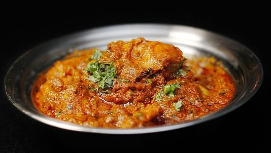 Chicken Tikka Masala plated in a steel dish