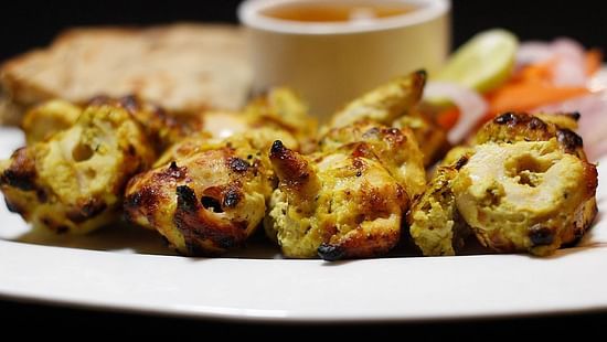 Reshmi Kebab plated in a white plate with a dip