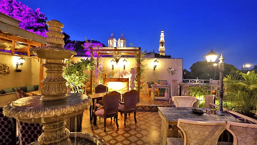 Open-air rooftop dining setup with scenic evening view