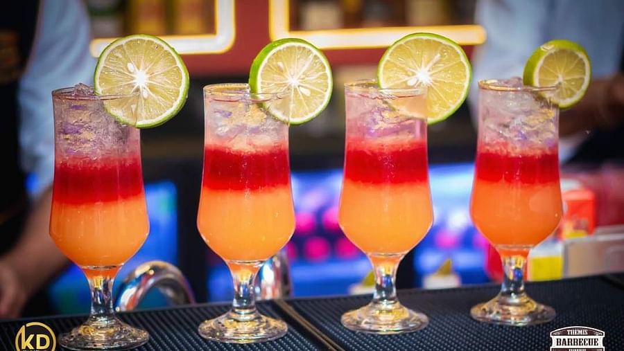 An image featuring four glasses of drinks placed on a table at Themis Barbecue House, NSP Pitampura