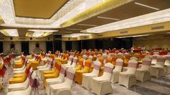 Theatre style seating arrangements inside the banquet hall with modern lights on the ceiling - VITS Bharat Nanded