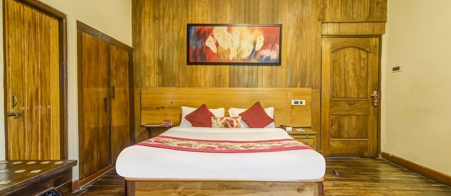 Deluxe cottage at Summit Barsana Resort & Spa, Kalimpong with a double bed