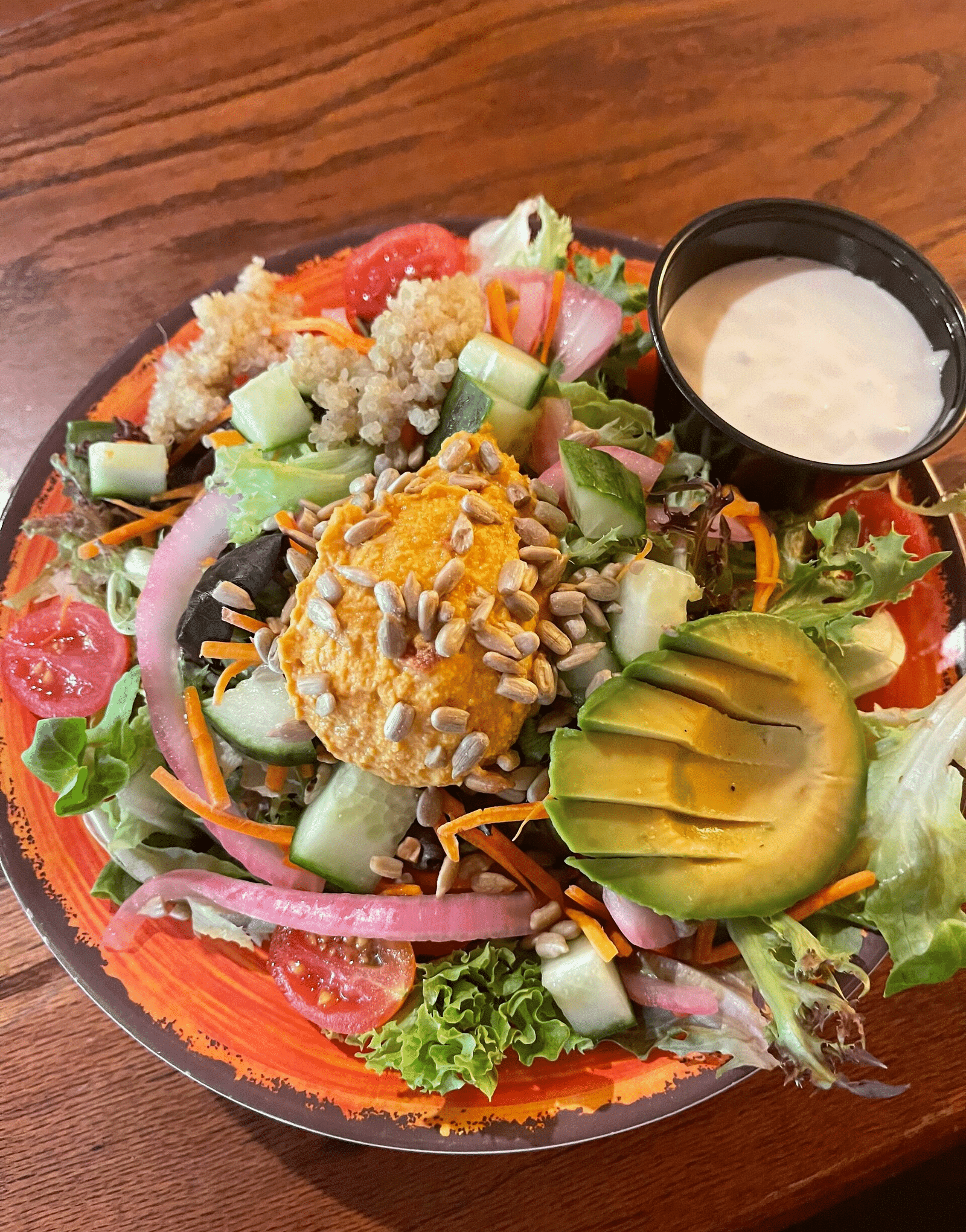 a bowl of a nutritious salad served with a salad dressing beside it at Tapoco Tavern - Historic Tapoco Lodge
