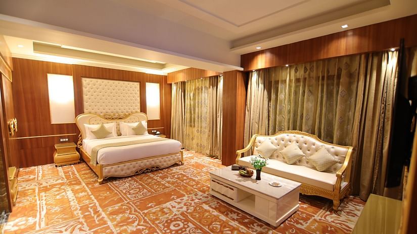 The Royal Suite featuring a bed and a white sofa