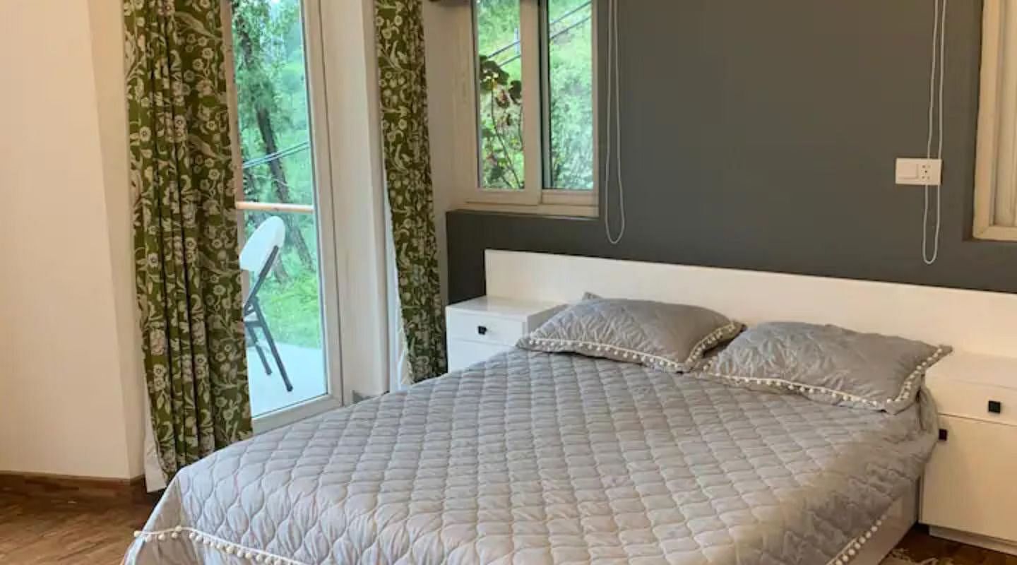A large bed in a bedroom  in 3 BHK at  at SOUTHGATE KASAULI BY ZENQ.