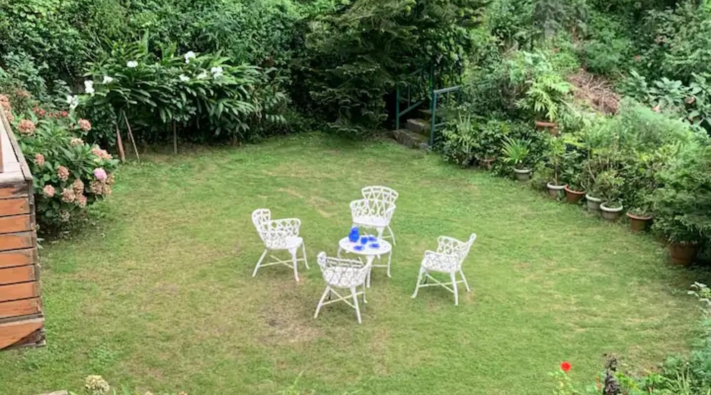Aerial view of the garden with lawn chairs around a table in 3 BHK at  in 3 BHK at SOUTHGATE KASAULI BY ZENQ.