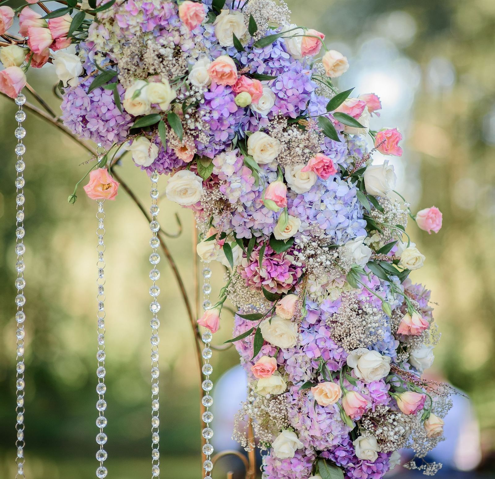 A close-up of an arc-shaped floral arrangement featuring a variety of vibrant flowers, decorative display that adds a touch of elegance.