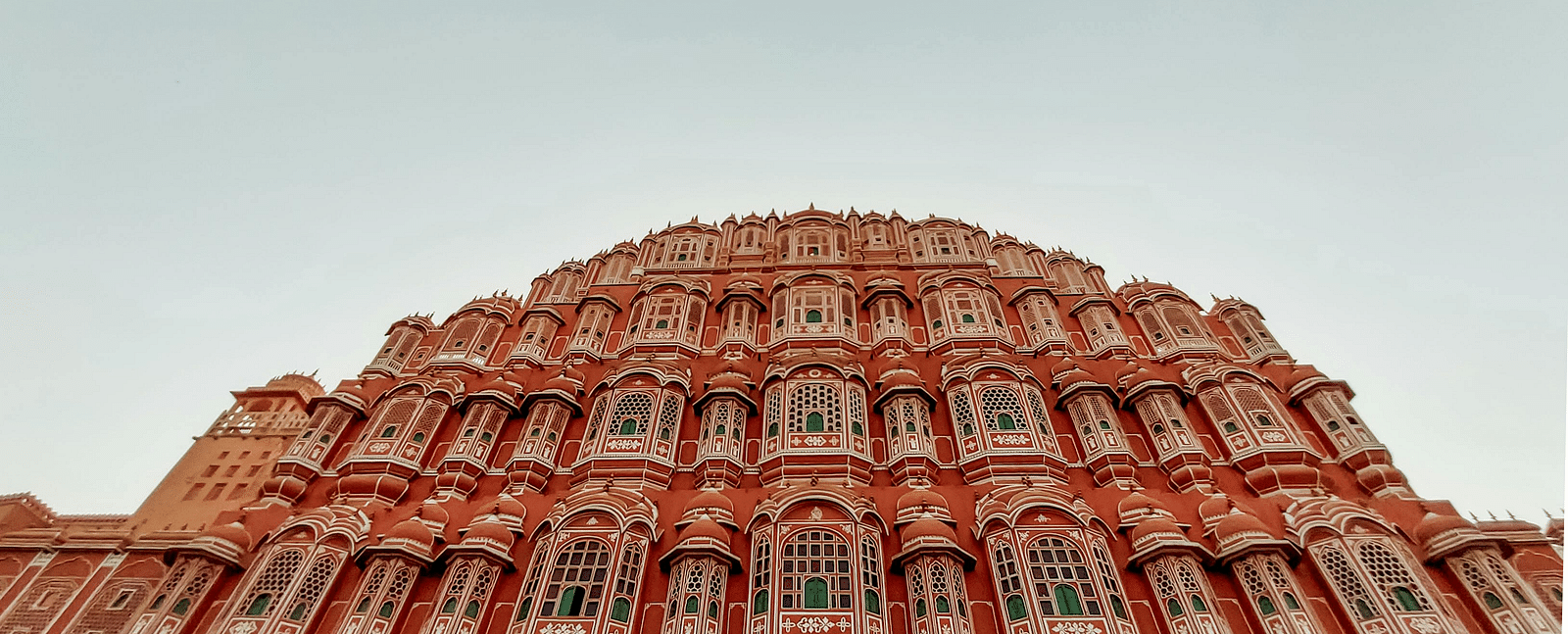 a low angle image of the Hawa mahal in Jaipur with a backdrop of a grey sky