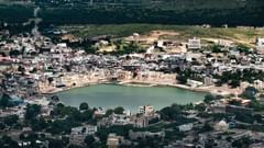 An aerial view of Pushkar temple and lake with hills and greenery in the background, located close to the Best Hotel in Pushkar Near Brahma Temple.