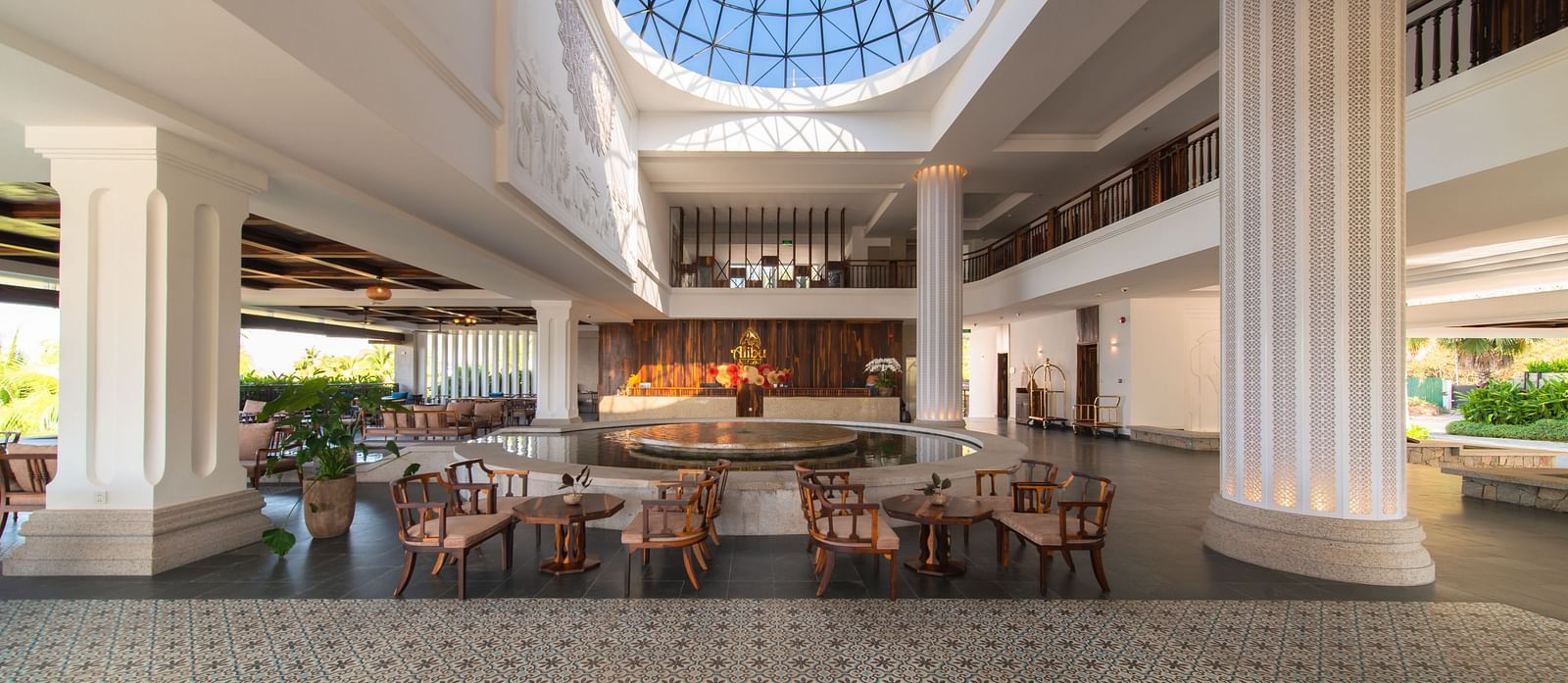 A huge lobby which has a sitting area with several chairs and tablesAn image of a huge sitting area of with several chairs and centre tables - Alibu Resort Nha Thrang