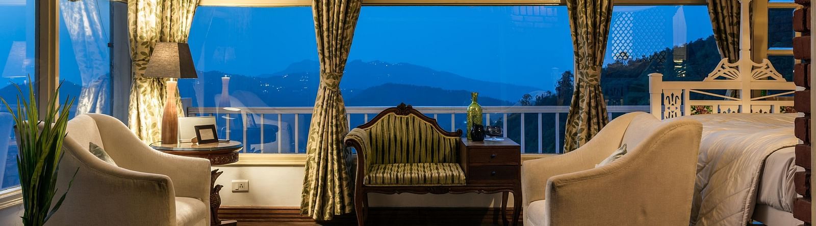 Sitting area with sofas and large window overlooking the mountains at Te Aroha by Shervani Mukteshwar