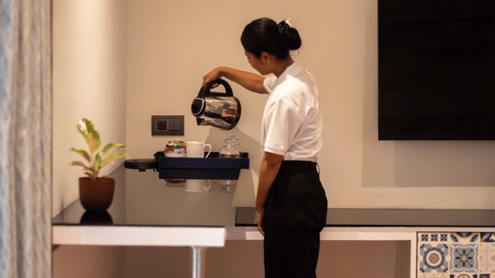 Staff preparing a drink at the beverage station in a room – Lamrin Morjim Goa