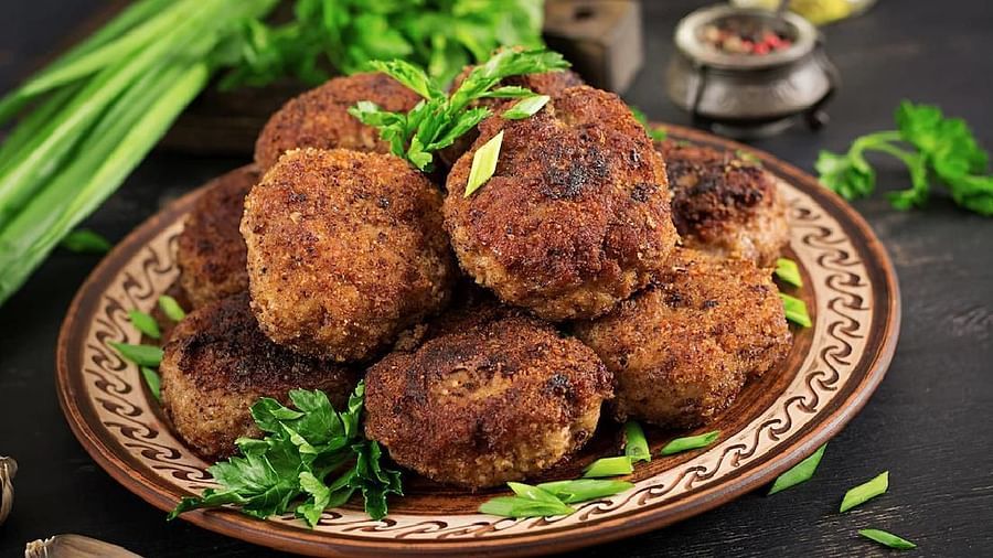 A plate of fried cutlets garnished with herbs