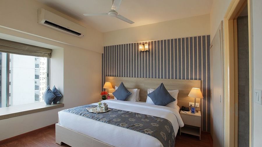 Deluxe room at Starlit Suites, Bangalore with a double bed during the day